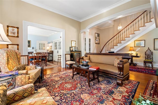 26 Julia St S, Mobile, AL 36604 - living room with decorative columns, hardwood / wood-style floors, stairway, crown molding, and arched walkways