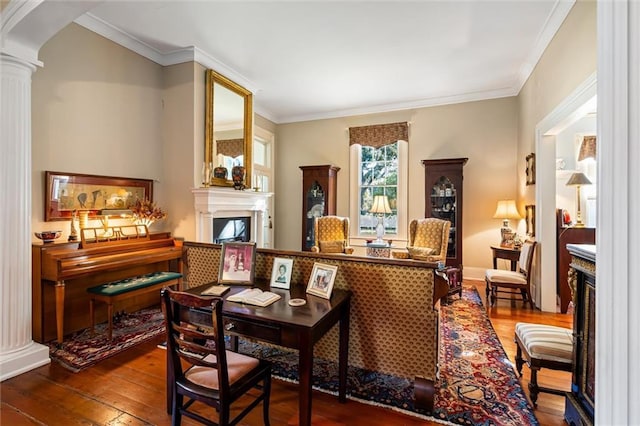 26 Julia St S, Mobile, AL 36604 - living area featuring a fireplace, wood-type flooring, decorative columns, ornamental molding, and arched walkways