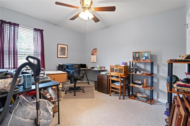 carpeted home office featuring ceiling fan and a textured ceiling