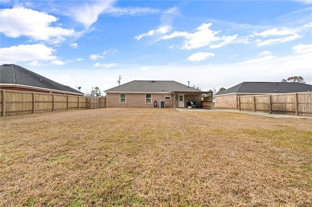 rear view of house featuring a yard