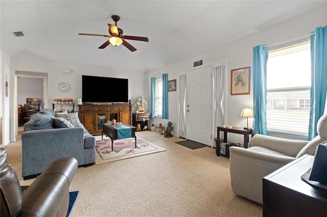 carpeted living room featuring ceiling fan