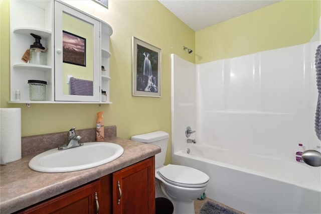 full bathroom with washtub / shower combination, vanity, toilet, and a textured ceiling