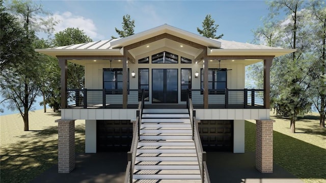 view of front of property featuring metal roof, a standing seam roof, an attached garage, and a balcony