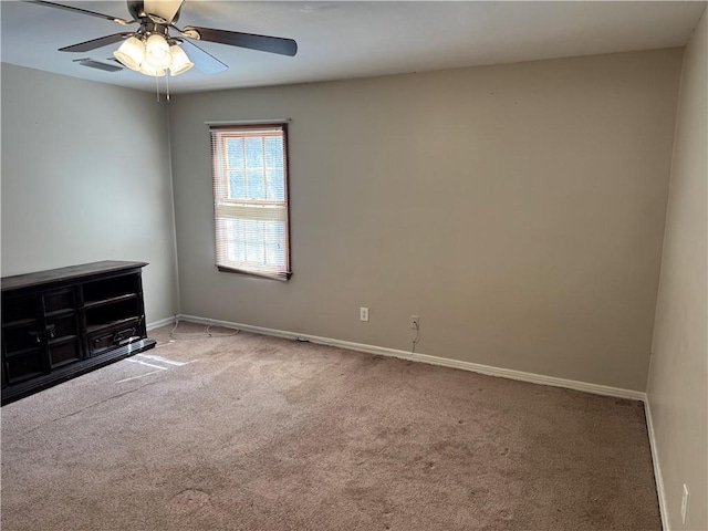 empty room featuring carpet, visible vents, and baseboards