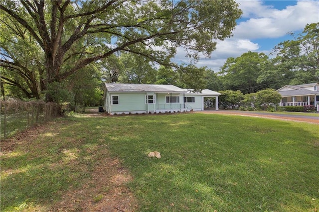 view of front of house with a front lawn and fence