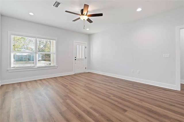 spare room with hardwood / wood-style floors and ceiling fan