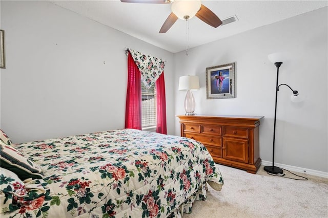 carpeted bedroom with baseboards, visible vents, and a ceiling fan