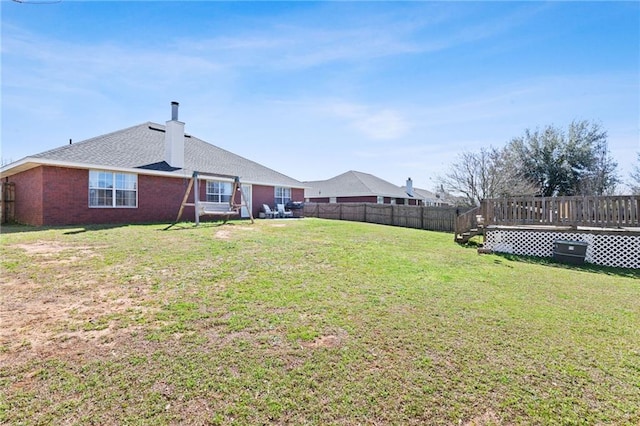 view of yard with fence and a deck