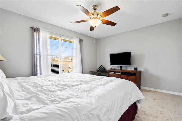 bedroom with light carpet, a ceiling fan, and baseboards