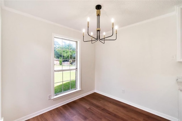 unfurnished dining area with a chandelier, dark wood-type flooring, baseboards, and crown molding