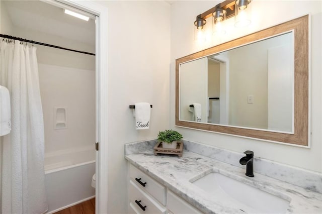 full bath with vanity, toilet, and shower / bath combo