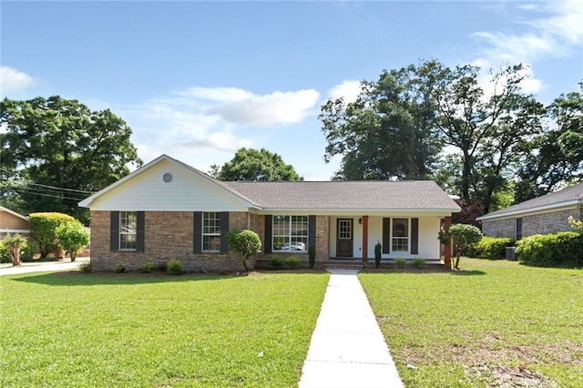 ranch-style home featuring a porch, a front yard, and brick siding