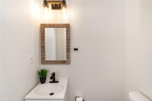 bathroom with toilet and vanity