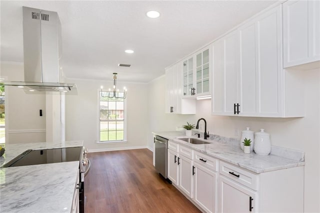 kitchen with island range hood, stainless steel appliances, a sink, wood finished floors, and white cabinetry