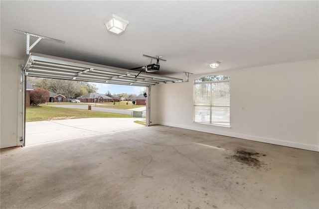 garage with a garage door opener and baseboards