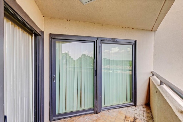 100 Tower Dr Unit 704, Daphne, AL 36526 - view of exterior entry with stucco siding and a balcony
