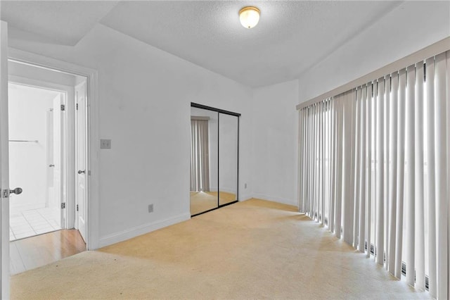 100 Tower Dr Unit 704, Daphne, AL 36526 - unfurnished bedroom with carpet floors, a textured ceiling, and a closet
