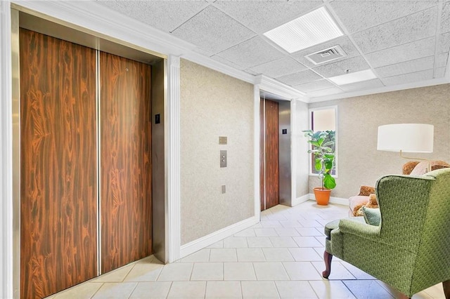 100 Tower Dr Unit 704, Daphne, AL 36526 - living area with elevator, light tile patterned floors, a drop ceiling, a textured wall, and crown molding