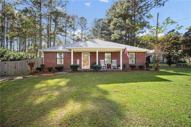 single story home featuring covered porch and a front yard