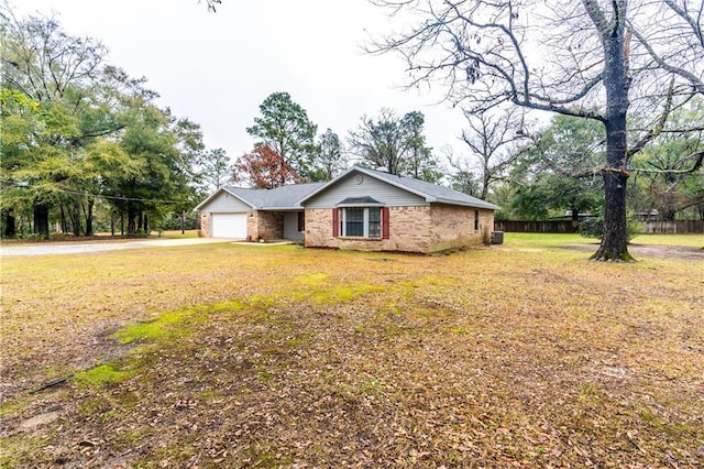 view of front of house with a garage and a front lawn