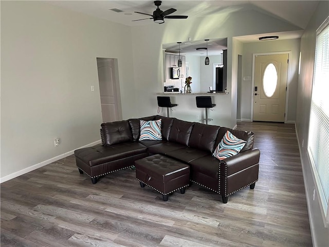 living room featuring wood-type flooring and ceiling fan