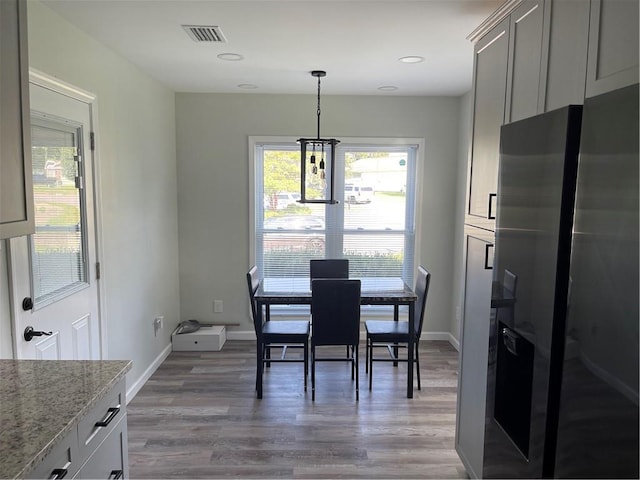 dining space featuring an inviting chandelier and hardwood / wood-style floors