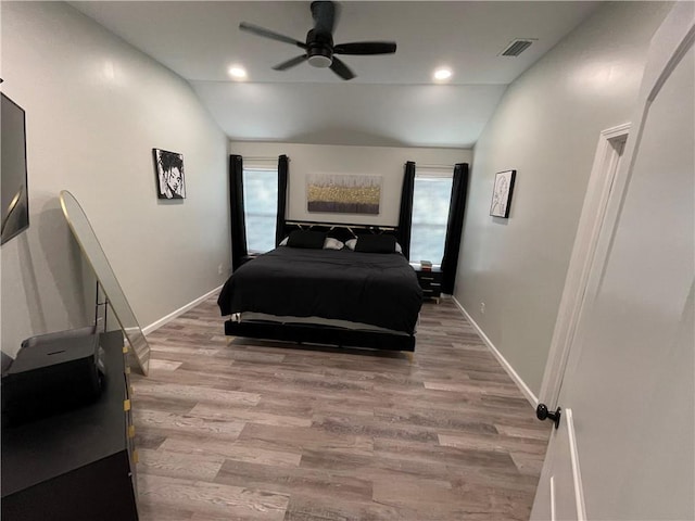 bedroom featuring lofted ceiling, light wood-type flooring, and ceiling fan