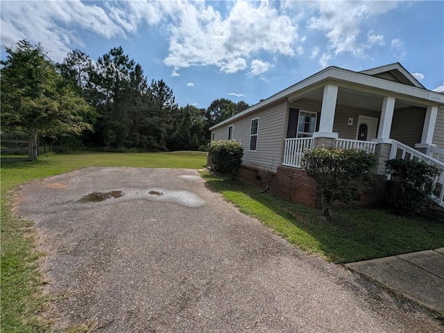 6960 March Pointe Ct, Theodore, AL 36582 - view of property exterior featuring covered porch, a yard, crawl space, and asphalt driveway