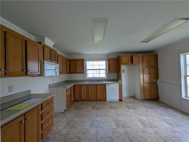 6960 March Pointe Ct, Theodore, AL 36582 - kitchen with white appliances, brown cabinetry, stone finish floors, and light countertops
