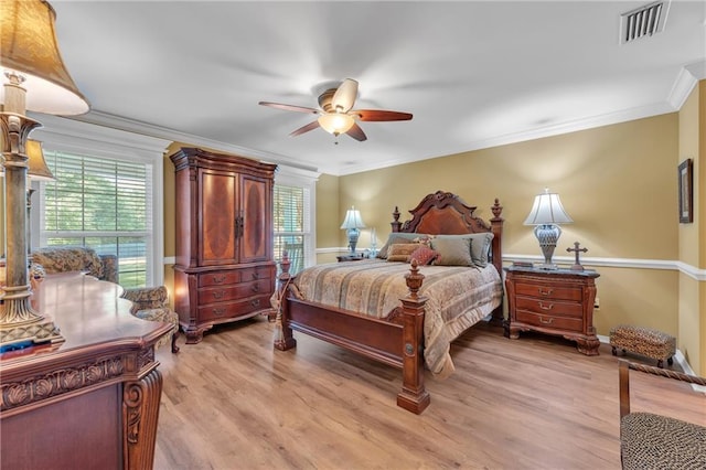 bedroom featuring ornamental molding, ceiling fan, light wood finished floors, baseboards, and visible vents