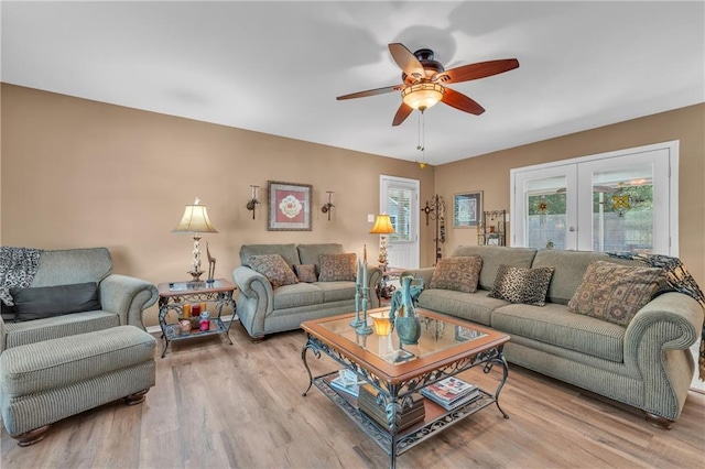 living area featuring ceiling fan, french doors, and wood finished floors