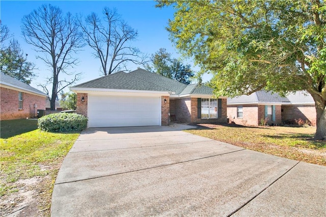 ranch-style house featuring an attached garage, brick siding, driveway, roof with shingles, and a front yard