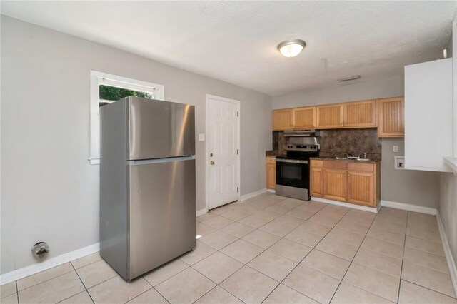 6451 Barker Dr S, Mobile, AL 36608 - kitchen featuring stainless steel appliances, light tile patterned floors, backsplash, and baseboards