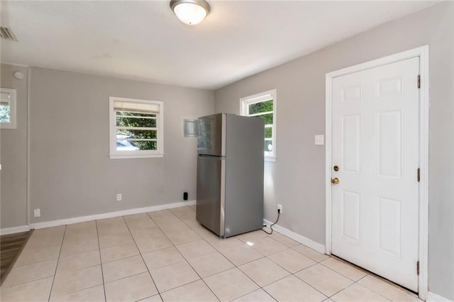 6451 Barker Dr S, Mobile, AL 36608 - kitchen featuring freestanding refrigerator, light tile patterned flooring, and baseboards