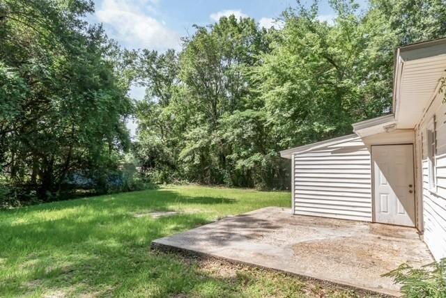 6451 Barker Dr S, Mobile, AL 36608 - view of grassy yard featuring a patio area and view of wooded area