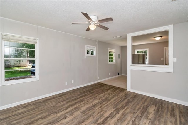 6451 Barker Dr S, Mobile, AL 36608 - spare room featuring wood finished floors, a ceiling fan, a textured ceiling, and baseboards