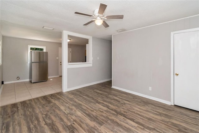 6451 Barker Dr S, Mobile, AL 36608 - spare room with wood finished floors, ceiling fan, a textured ceiling, and baseboards