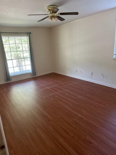 unfurnished room with ceiling fan and dark hardwood / wood-style flooring