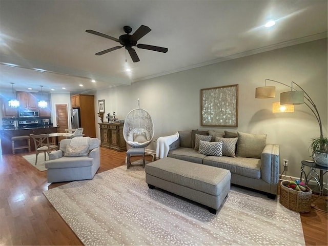 living room featuring ornamental molding, recessed lighting, ceiling fan, and wood finished floors