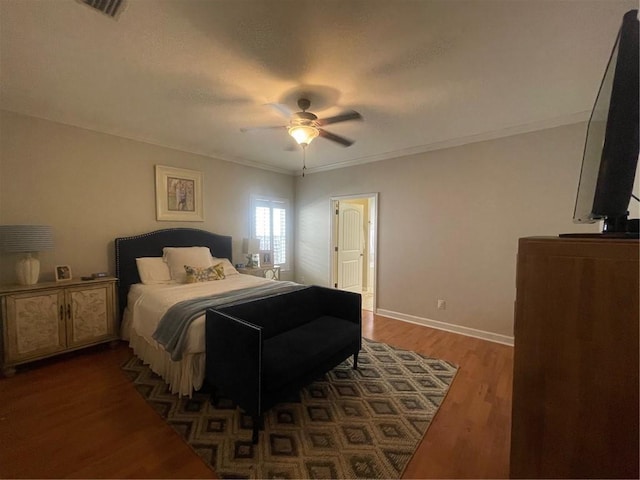 bedroom featuring ornamental molding, wood finished floors, a ceiling fan, and baseboards