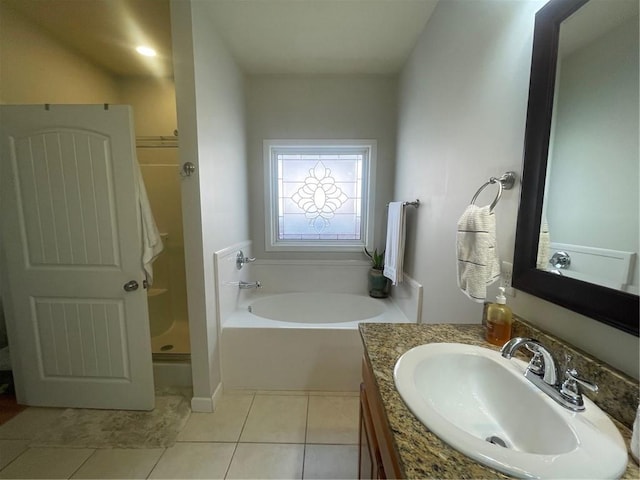 bathroom featuring a garden tub, a shower stall, vanity, and tile patterned floors