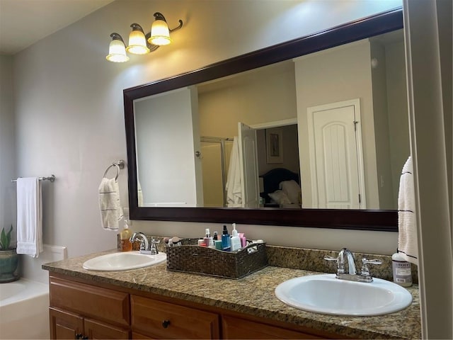 bathroom with double vanity, an enclosed shower, a sink, and a washtub