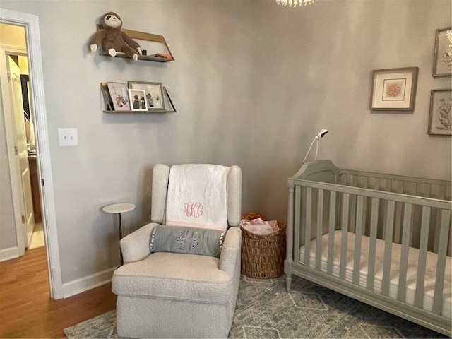 bedroom with baseboards and wood finished floors