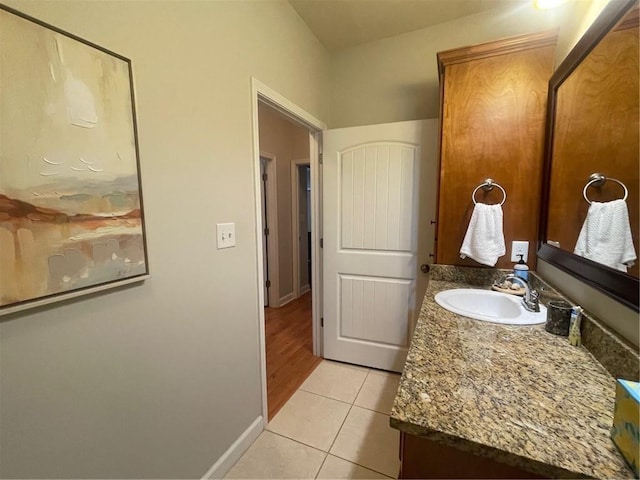 bathroom featuring tile patterned flooring, vanity, and baseboards