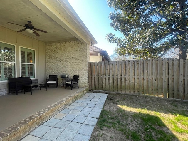 view of patio / terrace with a ceiling fan and fence