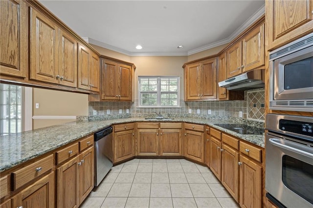 kitchen with tasteful backsplash, light tile patterned flooring, light stone countertops, and appliances with stainless steel finishes