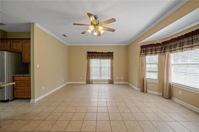 tiled empty room with crown molding and ceiling fan