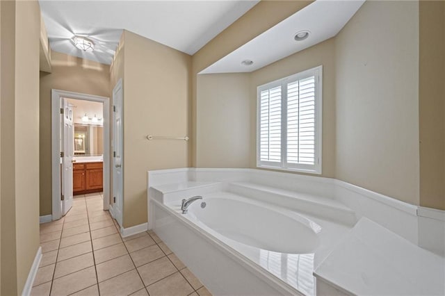 bathroom with vanity, a washtub, and tile patterned floors