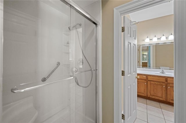 bathroom featuring vanity, an enclosed shower, and tile patterned flooring