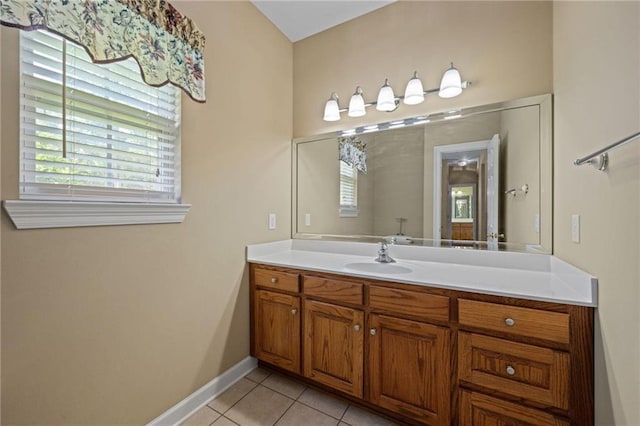 bathroom with tile patterned flooring, vanity, and a wealth of natural light